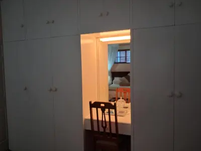 a room with a table with a chair and a mirror at Marinda's B&B in Cape Town
