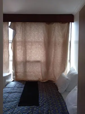 a bedroom with a bed with a canopy and a window at 37 Toner Street North in Cape Town