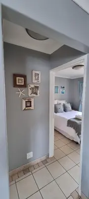 a bedroom with a bed in the corner of a room at Ocean Escape in Strand