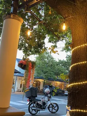a motorcycle parked next to a building with lights at Studio 23 @ Huis Piron. The Heart of Stellenbosch. in Stellenbosch