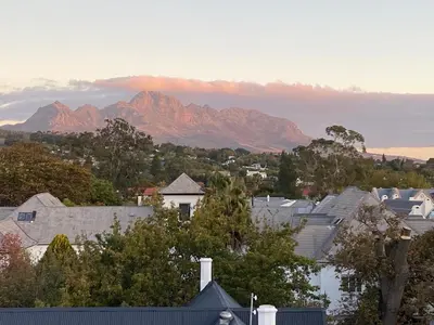 a view of a city with mountains in the background at Studio 23 @ Huis Piron. The Heart of Stellenbosch. in Stellenbosch