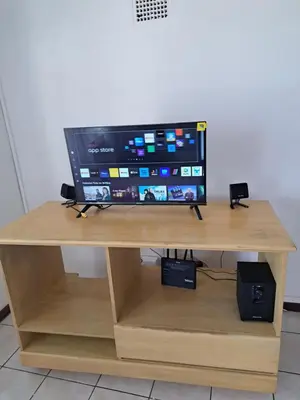 a television sitting on top of a wooden desk at A cosy home in Hermanus in Hermanus