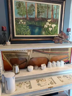 a painting above a shelf with bowls and cups at Chapman View Studio in Cape Town