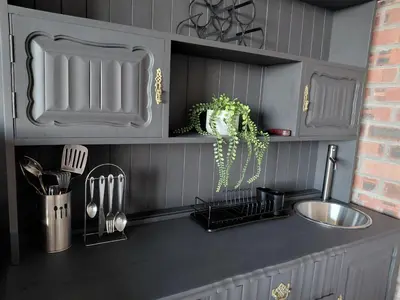 a kitchen with gray cabinets and a counter top with a sink at Chapman View Studio in Cape Town