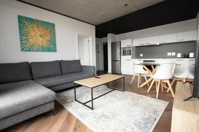 a living room with a couch and a table at 9 Palms by Smart City Stays in Cape Town