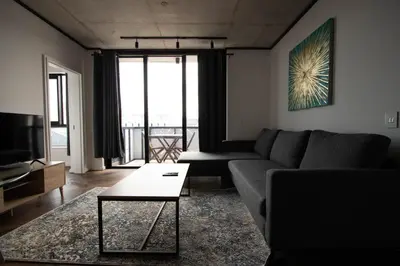 a living room with a couch and a table at 9 Palms by Smart City Stays in Cape Town