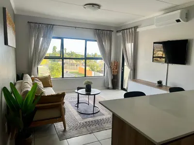 a living room with a couch and a table at The CoziPlace One in Cape Town