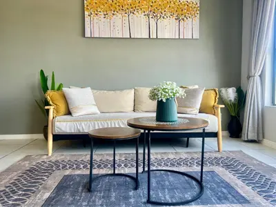 a living room with a couch and a table at The CoziPlace One in Cape Town