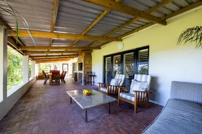 a porch with a couch and chairs and a table at Florie se Huis in Paarl