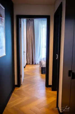 a hallway with a door open to a bedroom with a bed at KML Nine Palms luxury 101 in Cape Town