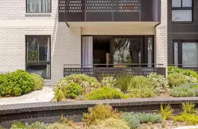 a house with a garden in front of it at KML Nine Palms luxury 101 in Cape Town