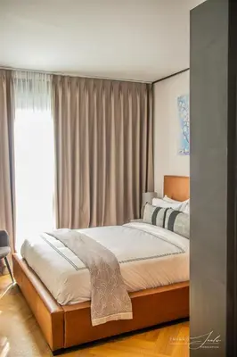 a bedroom with a bed and a window at KML Nine Palms luxury 101 in Cape Town