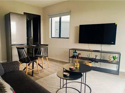 a living room with a couch and tables and a tv at NEW BOSTON in Bellville