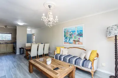 a living room with a couch and a table at Dorphene 304 by CTHA in Cape Town