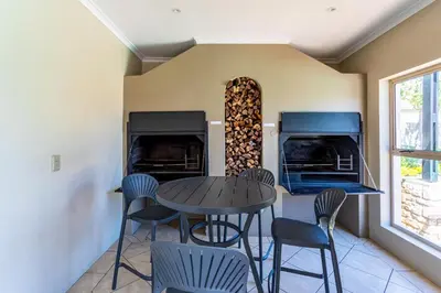 a dining room with a table and chairs at Dorphene 304 by CTHA in Cape Town