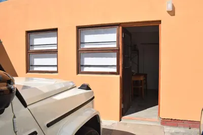 a car parked in front of a building with windows at House on Pringle in Cape Town