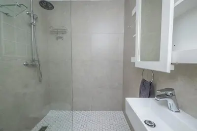 a bathroom with a shower and a sink at Island view on Clam in Cape Town