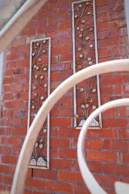a brick wall with two windows on it at At Hummingbird Hill Hermanus in Hermanus