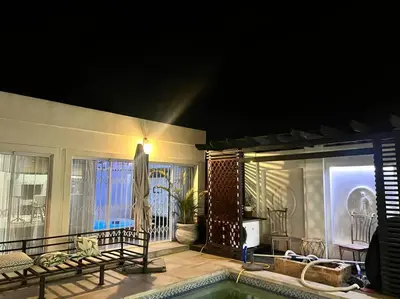 a house with a swimming pool and a patio at Apartment on 32 in Cape Town