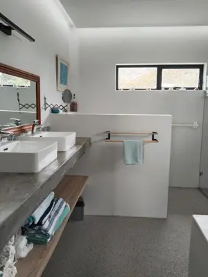 a bathroom with two sinks and a mirror at Prinia on Peak holiday home in Pringle Bay