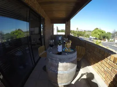 a patio with a table with two glasses of wine at Blue Mountain View in Cape Town