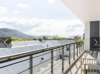a balcony with a view of the mountains at Franschhoek - La Petit Village - Views in Franschhoek