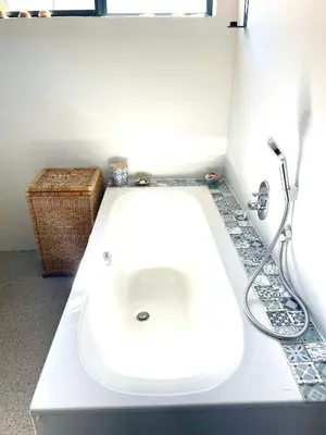 a bathroom with a white sink and a shower at Prinia on Peak in Pringle Bay in Pringle Bay