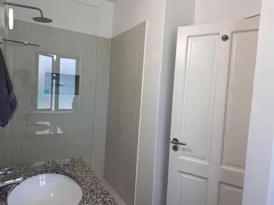 a bathroom with a sink and a toilet and a mirror at Sunset Studio Garden View in Cape Town
