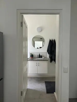 a bathroom with a sink and a mirror at Sunset Studio Garden View in Cape Town