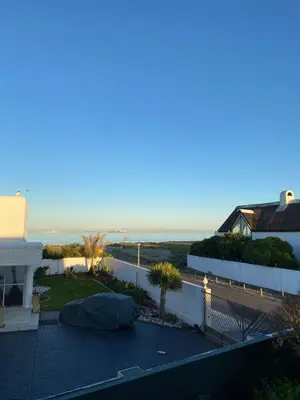 a view of the beach from the balcony of a house at Sunset Studio Garden View in Cape Town