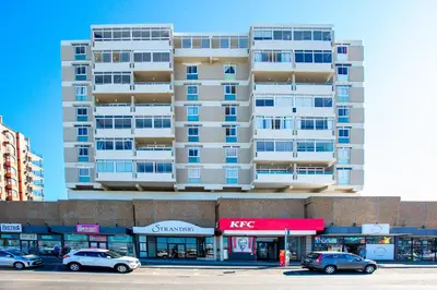a tall building with cars parked in front of it at Isla's Place (Strandsig 304) in Cape Town