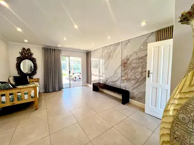 a large living room with a fireplace and a mirror at Villa Lamsyh- your second home in Cape Town