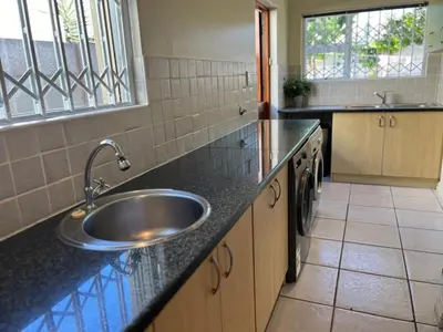 a kitchen with a sink and a counter at 4 Bedroom Bliss in Cape Town