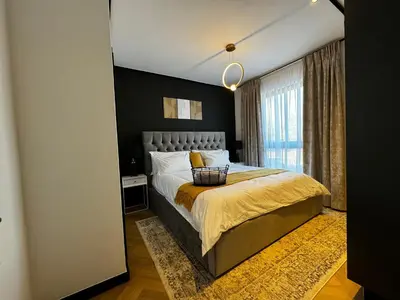 a bedroom with a large bed and a window at S.A.E. Nine Palms Luxury in Cape Town