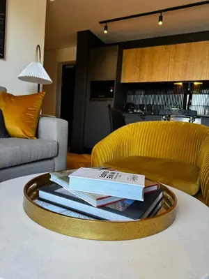 a coffee table with books on it in a living room at S.A.E. Nine Palms Luxury in Cape Town