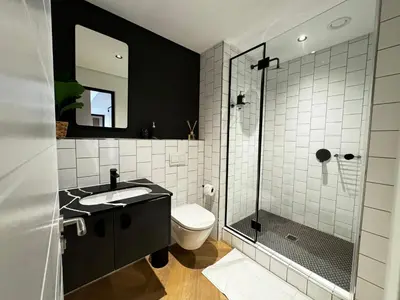 a bathroom with a toilet and a sink and a shower at S.A.E. Nine Palms Luxury in Cape Town