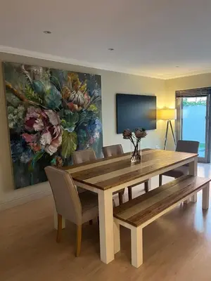 a dining room table and chairs with a painting on the wall at La Gratitude 8 luxury in Stellenbosch CENTRAL in Stellenbosch
