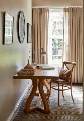 a desk with a lamp and a chair next to a window at Boschendal Farm Estate in Franschhoek
