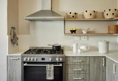 a kitchen with a stove and some shelves at Boschendal Farm Estate in Franschhoek