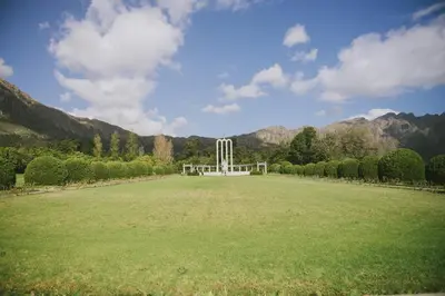 a large grass field with a white object in the middle at Maison Des Huguenots Le Roux in Franschhoek
