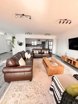 a living room with two couches and a coffee table at 2nd on Strand in Cape Town