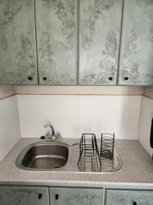 a kitchen sink with two chairs sitting next to it at Stirling House in Paarl