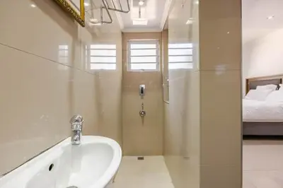 a bathroom with a sink and a bed at One bedroom apartment. in Cape Town