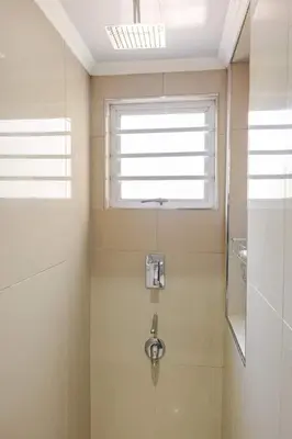 a bathroom with a shower with a window and a sink at One bedroom apartment. in Cape Town