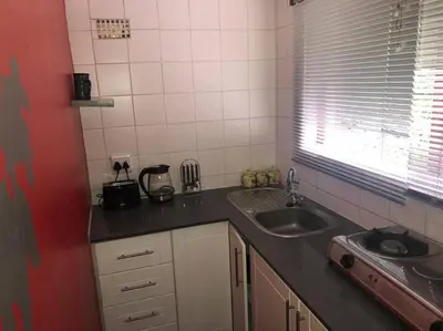 a kitchen with a sink and a counter top at Sundance in Central Greyton in Greyton