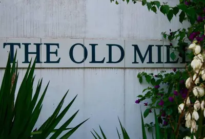 a sign that says the old mill on a wall at PONDOKKIE in Greyton