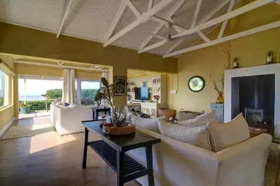 a living room with a couch and a table at Dieu Donne in Hermanus