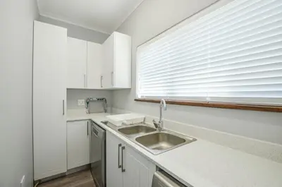 a kitchen with a sink and a window at The Neighbours - Kleinmond in Kleinmond