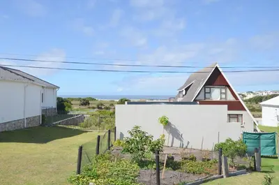 a house with a painting of a giraffe on a wall at The Neighbours - Kleinmond in Kleinmond
