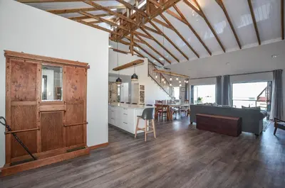 a kitchen and living room with a couch and a table at The Neighbours - Kleinmond in Kleinmond